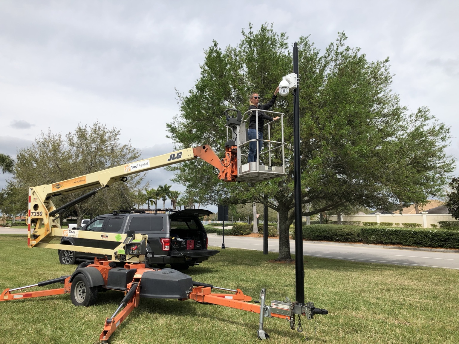 Jamie from SCS working from a lift on an outdoor security camera installation